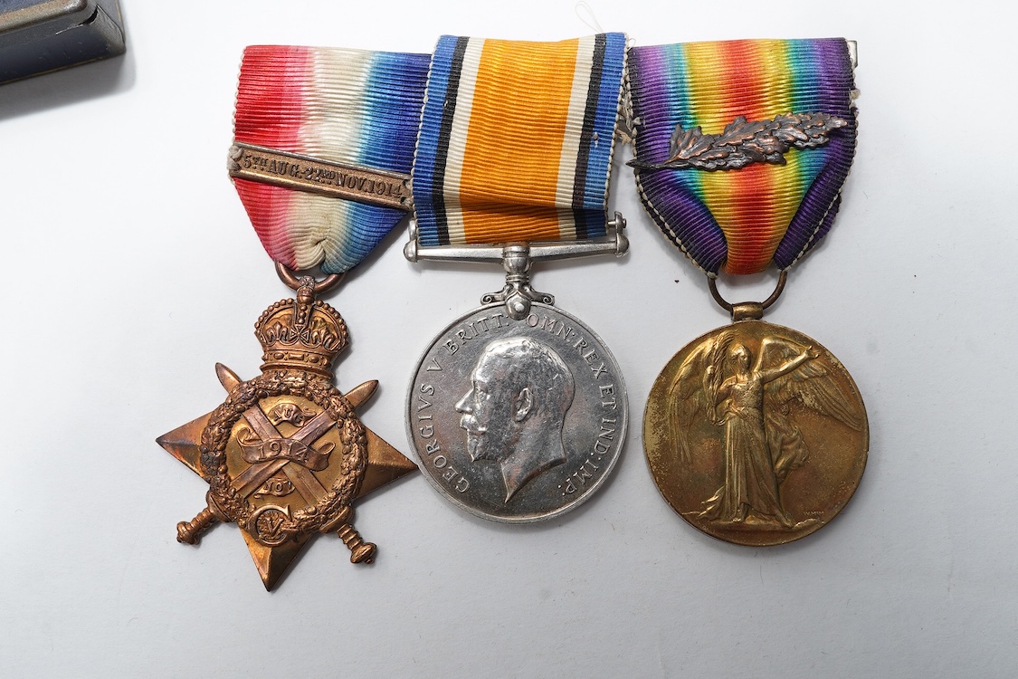 A First World War Mons Star trio awarded to Capt. A.D. Lowdell, with a clasp for 5th Aug-22nd Nov 1914, and oakleaf - mention in dispatches, together with the miniature set, plus a WWII Defence medal in its original card
